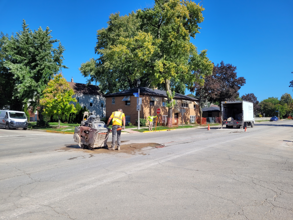 Workers removing curb and gutter along 16th Street.